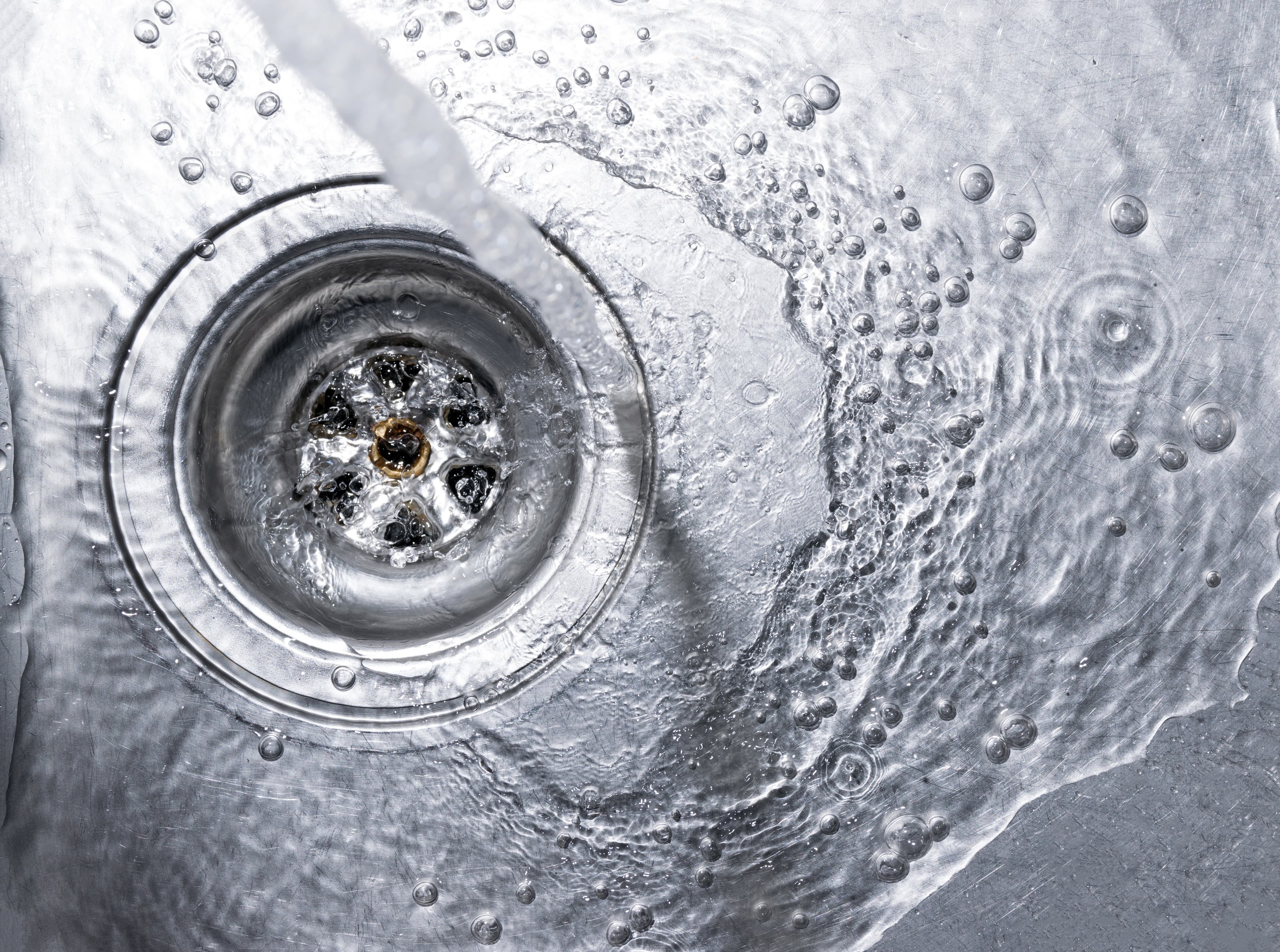 Chlorinated municipal tap water filling a glass at a Cape Coral kitchen sink