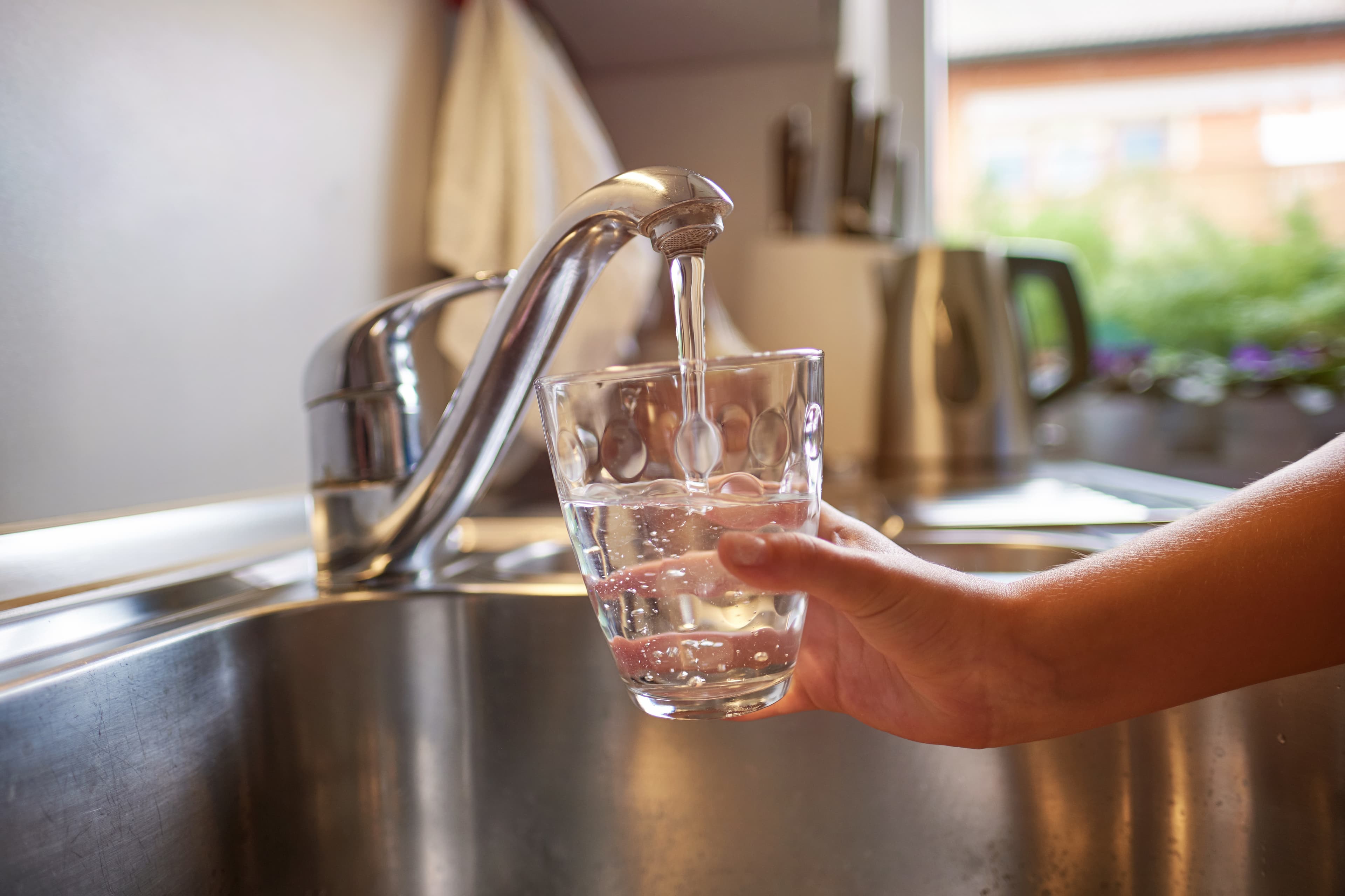 Discolored tap water from a well before iron and sulfur treatment